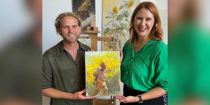 Local artist Chapman Hamborg and Becks Heyhoe-Khalil, Executive Director of United to End Homelessness, Orange County United Way, holding Unseen Paths artwork.
