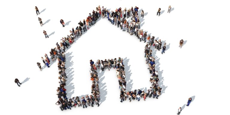 Aerial photo of people creating shape of house.